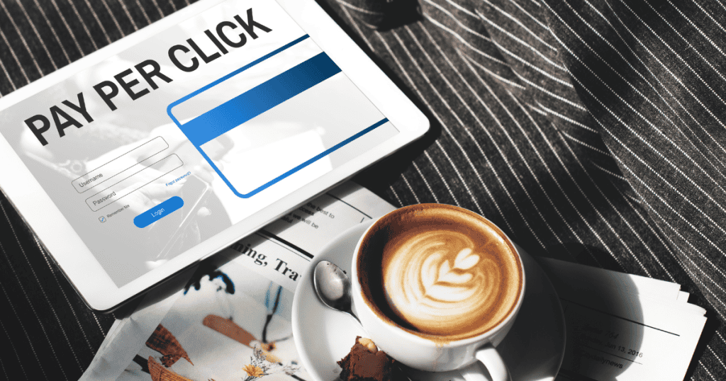 A tablet showing a "Pay Per Click" interface sits next to a cup of coffee, signifying the shift toward financial transactions and the security needs they trigger.