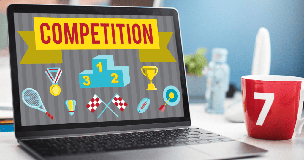 A laptop displays colorful competition graphics including a podium and medals next to a red mug, hinting at the potential pitfalls of managing promotional events online.