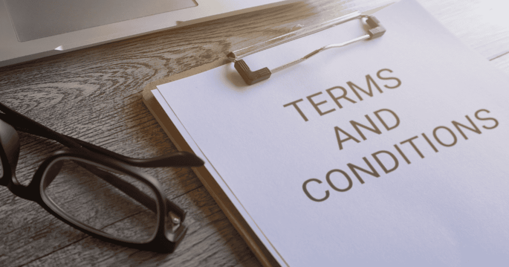 A pair of glasses sits next to a clipboard labeled "Terms and Conditions," representing the clear vision needed to establish site rules.