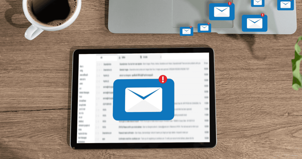 Digital mail icons float above a tablet and laptop on a desk, showcasing the gradual process of establishing a direct line of communication with an audience.