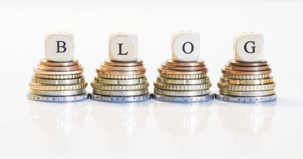 Four wooden letter blocks spelling "BLOG" sit atop stacks of gold and silver coins, representing the financial potential unlocked by turning readership into revenue.