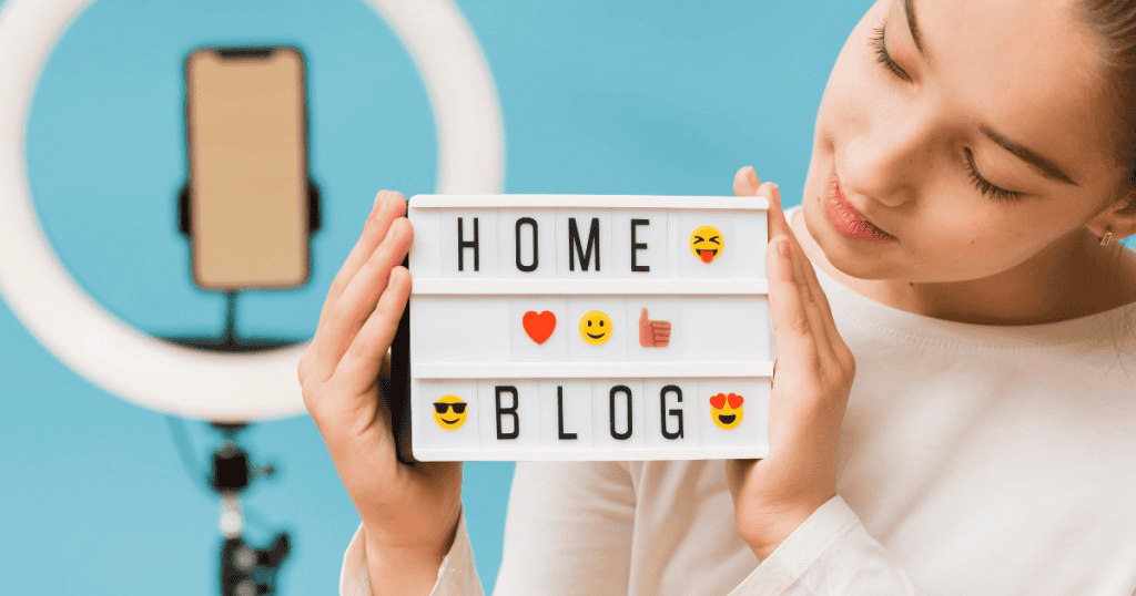 A young creator holds a mini light box sign featuring text and emojis in front of a recording setup, capturing the moment of establishing a unique identity for an online presence.