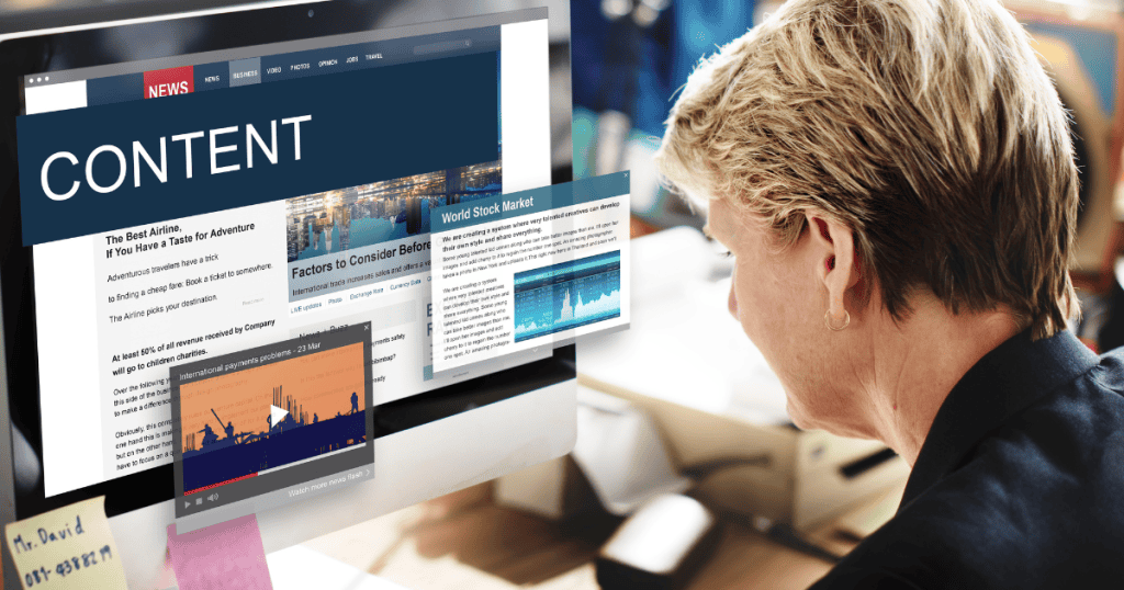 A woman looks intently at a computer monitor displaying a digital media interface, focusing on the creative process of drafting the inaugural article for publication.