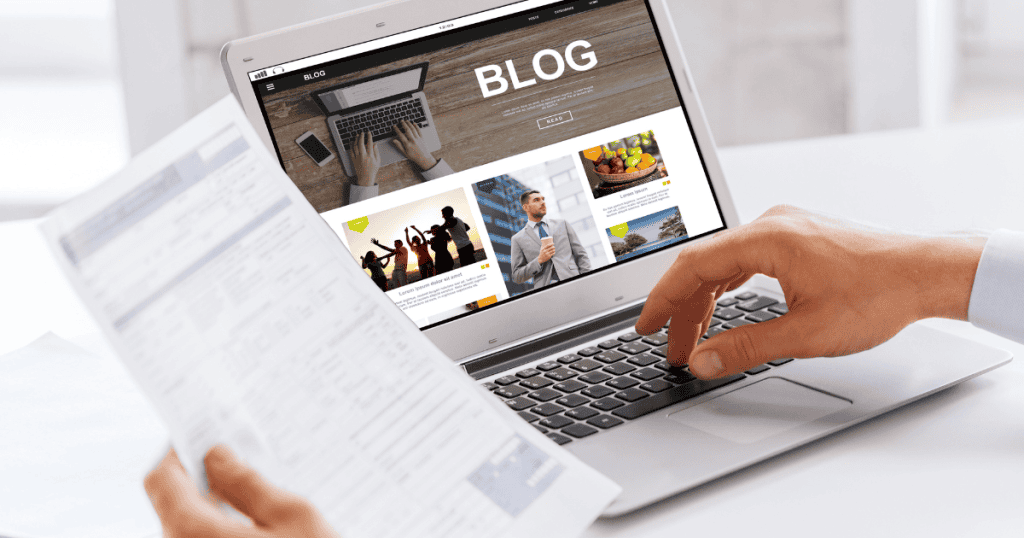 A person compares a printed document to a blog layout on a laptop screen, highlighting the strategic integration of essential site information.