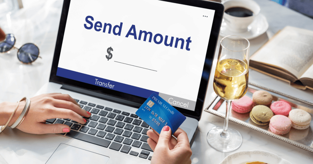 A person holds a credit card while looking at a "Send Amount" screen on a laptop, illustrating the moment a creator decides whether to invest in professional tools.