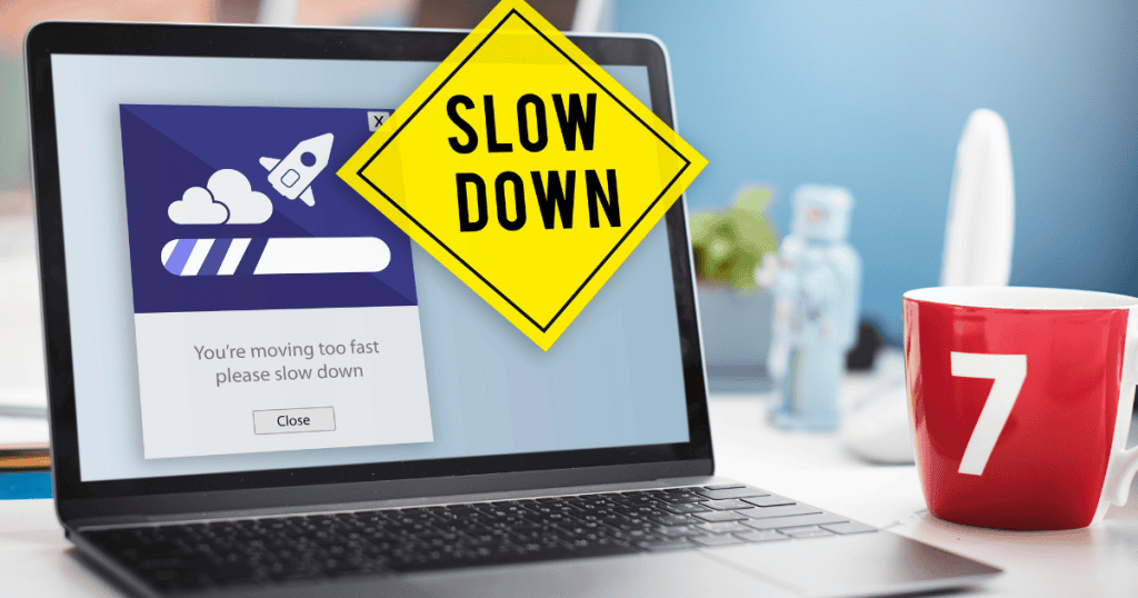 A laptop screen displaying a "slow down" warning message, reflecting the friction caused by mismanaged scaling efforts.