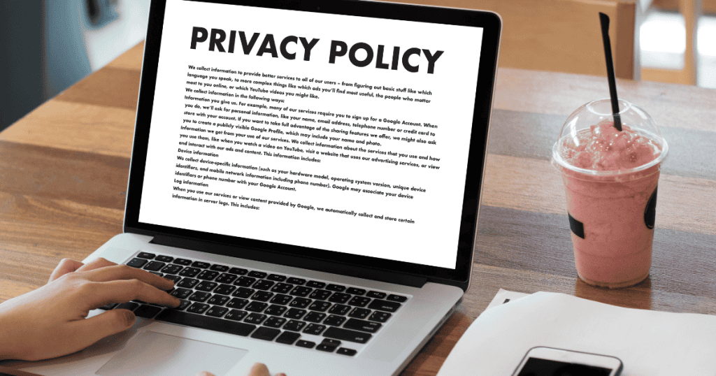 A person scrolls through a dense document on a laptop screen while sitting at a cafe, representing the review of formal standards that protect digital visitors.