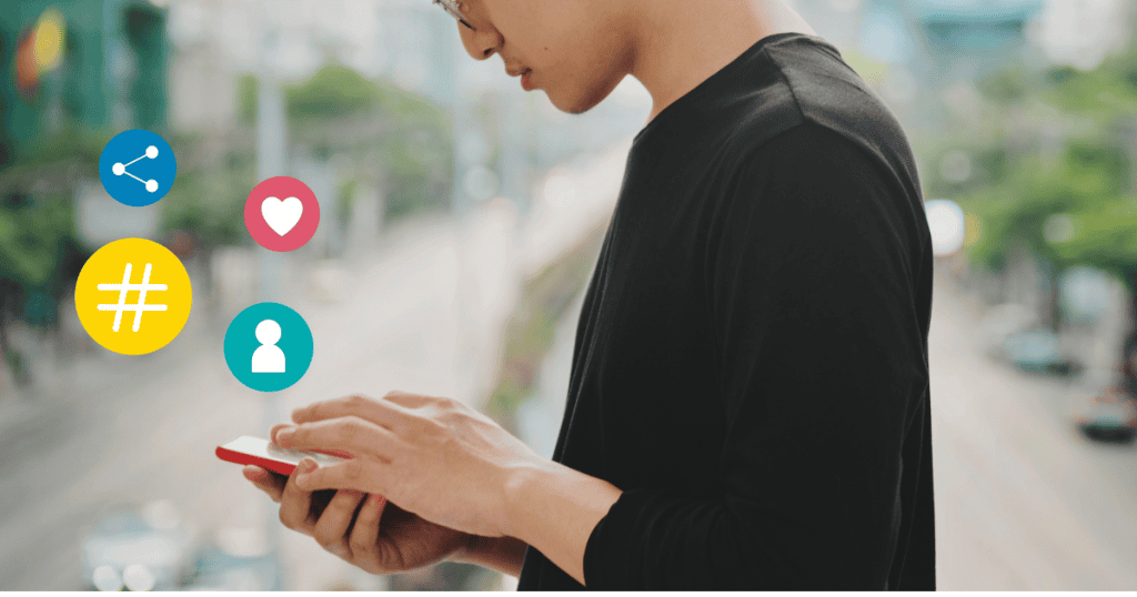 A man in a black shirt looks down at his smartphone while standing outdoors, surrounded by floating icons that suggest he is engaging with digital content on the go.