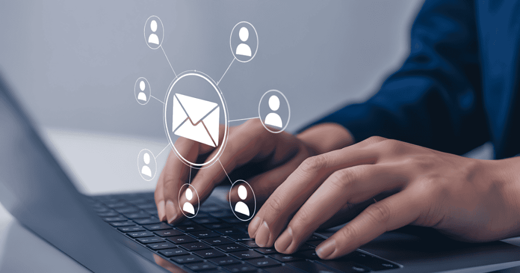 Hands type on a keyboard beneath a digital overlay of an envelope connected to several people icons, illustrating how active interaction powers a financial network.