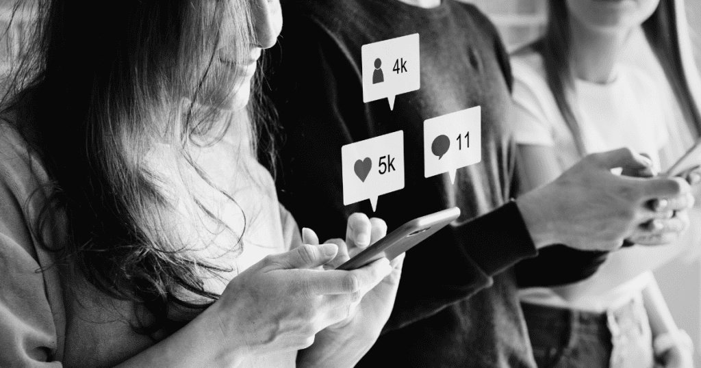 A black and white photo depicts people using smartphones with digital likes and comments floating above them, illustrating the visible divide between high and low interaction.
